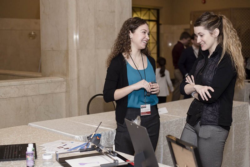 Two people having a discussion at a conference